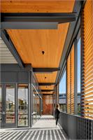 Sliding wood screens help manage glare and heat gain while creating varied intimate indoor outdoor spaces at the Janet Guild and Commons
